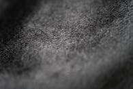 Macro shot showcasing the intricate texture of black fabric material.